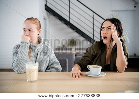 Young Women Friends Offended In Cafe While Drinking Coffee