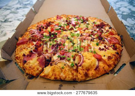 Pizza. Hawaiian Pizza. Pineapple Pizza. Pizza with pineapple, ham, onions, cheese, tomatoes, bacon, and sauce. 

