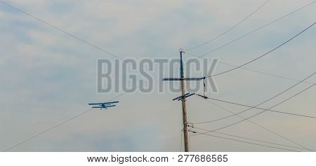 Military Biplane In Cloudy Sky