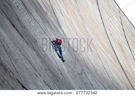 Finkenberg, Austria - June 9, 2018: An Alpinist Climbing The Via Ferrata On The Schlegeis Dam