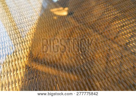 Rattan Table Under Glass With Reflection Of Blue Sky In The Sunlight