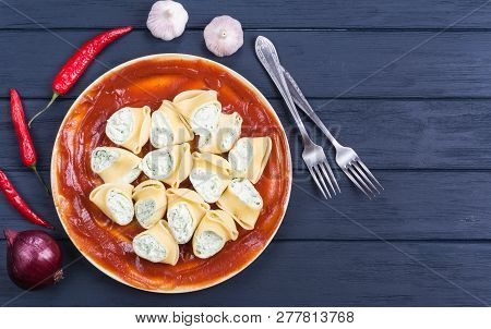 Delicious Lumaconi Pasta Meal With Cheese And Tomato Sauce