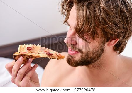 Food Delivery Service. Sexy Man Eat Pizza Lying On Bed. Young Man Resting At Home With A Nude And A 