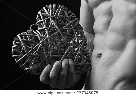 Athletes Body In Close Up, Hand Holding Big Rattan Heart