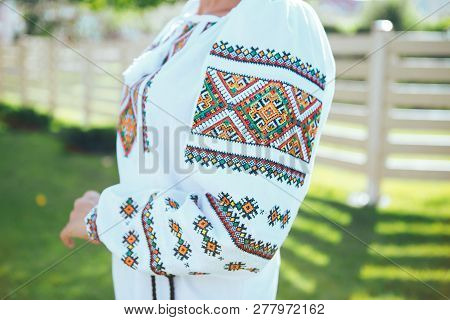 Beautiful Young Woman In Traditional Ethnic Ukrainian  Style. Vyshivanka Blue With White Embroidery