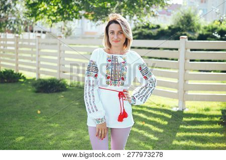 Beautiful Young Woman In Traditional Ethnic Ukrainian  Style. Vyshivanka Blue With White Embroidery