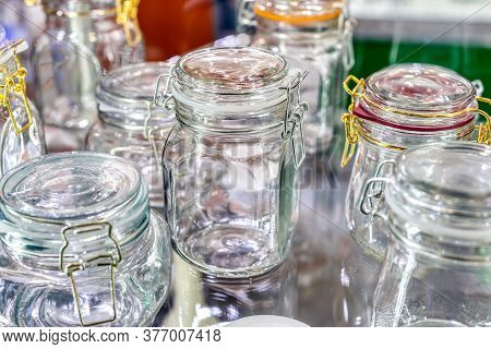 Glass Jars With Glass Lockable Lids. Stand On A Shelf A Shop Window.