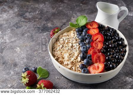 Healthy Breakfast, Muesli With Currants, Blueberries And Strawberries In Bawl On Dark Backgrund
