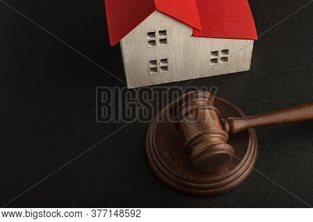 Mallet Of Judge And Model House On Black Background. Real Estate Auction. Confiscated Housing. Resol