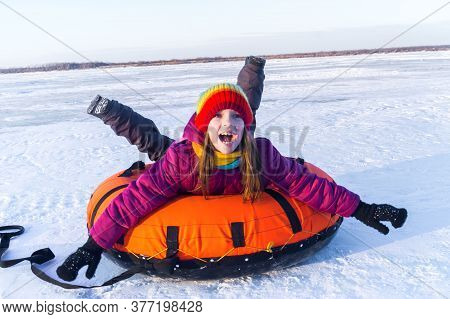 Young Smiling Girl Ride Sleigh Snow Tubing