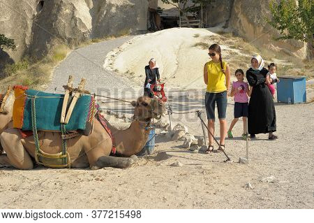 Camel Near A Rock Formation In Turkey. Cappadocia