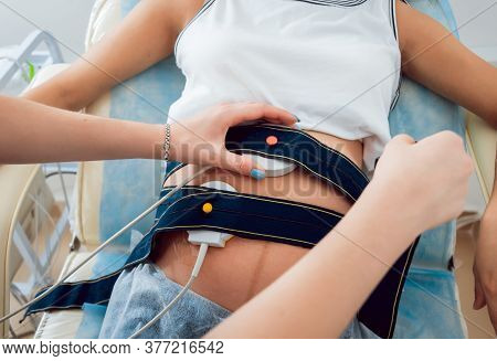 Pregnant Woman With Electrocardiograph Check Up For Her Baby.