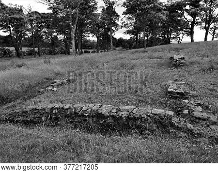 A View Of The Ruins Of The Ancient Roman Fort At Bar Hill And Part Of The Antonine Wall In Scotland.