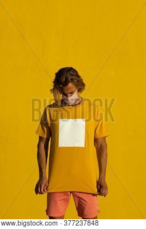 Blond Young Man With Mask On A Yellow Background