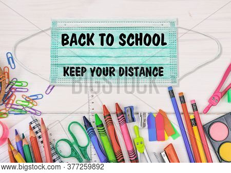 Back To School, Keep Your Distance  Text On A Surgical Mask. Coronavirus Spread Prevention Measure