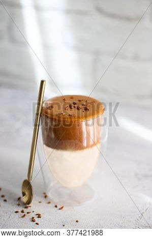Iced Dalgona Coffee On White Concrete Background. Trendy Creamy Whipped Coffee