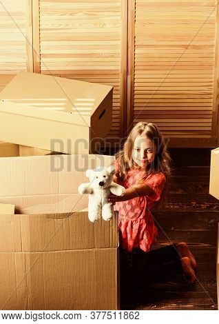 Box Package And Storage. Small Child Prepare Toys For Relocation. Happy Childhood. Relocating Family