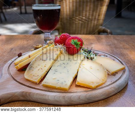 Tasting Of Different Belgian Cheeses And Dark Strong Belgian Beer Served Outdoor Close Up