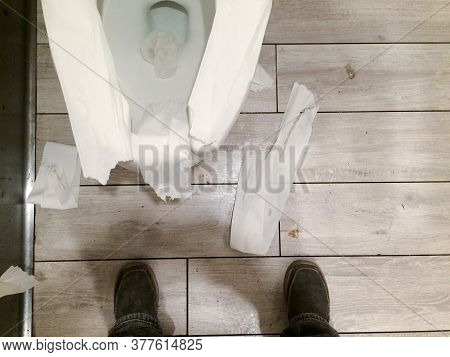 Messy Public Restroom With Toliet Paper All Over