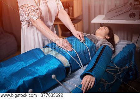 Woman Lying On Body Pressotherapy Machine In Beauty Center