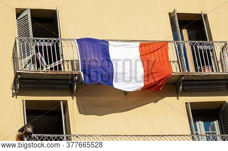 Briancon, France - July 7, 2020: French National Flag Hung Before The Holiday Of July 14 On The Balc
