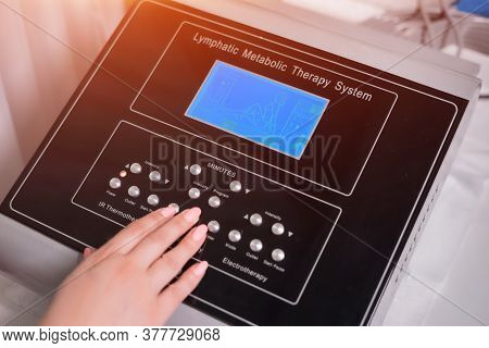 Doctor Setting Up Pressotherapy Machine For Slimming In Spa Salon