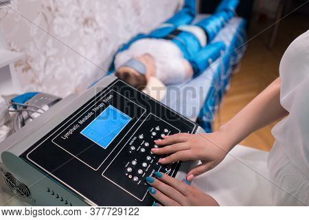 Doctor Setting Up Pressotherapy Machine For Slimming In Spa Salon
