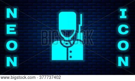 Glowing Neon British Guardsman With Bearskin Hat Marching Icon Isolated On Brick Wall Background. Ve