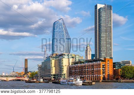 LONDON,UK - AUGUST 19,2019 : Waterfront apartment buildings and a view of the river Thames in London