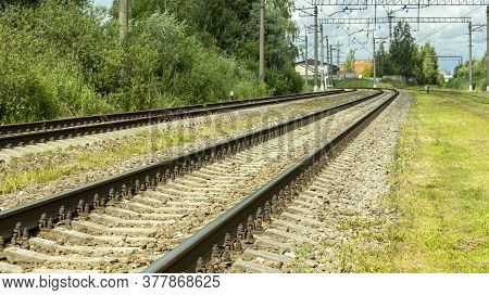 Electric Train Tracks On A Bright Sunny Day