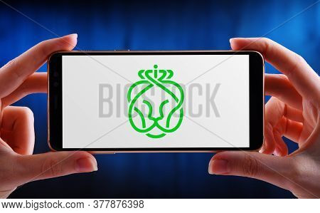 Hands Holding Smartphone Displaying Logo Of Ahold Delhaize