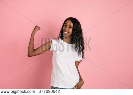Strong, Power. Cheerful African-american Young Woman Isolated On Pink Background, Emotional And Expr