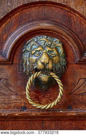 Old Venetian Metal Veneto Lion Head Door Knocker On The Wooden Door Of Old Venice Palace