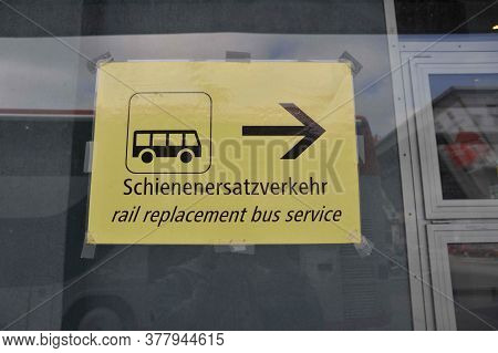 Yellow Rail Replacement Bus Service Sign, Black Letters And Pictogram, English And German (schienene