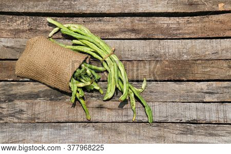 Yardlong Bean Or Pea Bean Isolated On Wooden Background, Also Known As Asparagus Bean