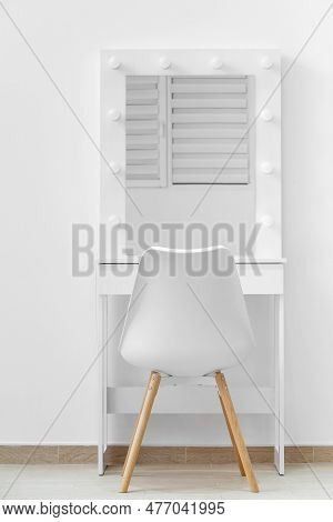 White Dressing Table For Make-up With A Large Mirror And Lamps, A White Chair Against The Background