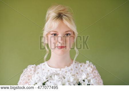 Beauty Portrait Of Pretty Young 15 - 16 Year Old Teeenage Girl Wearing White Dress Posing On Green B