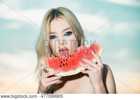 Portrait Of A Beautiful Young Blonde Woman With Blue Eyes Eating Watermelon.