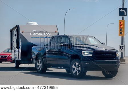 Calgary, Alberta, Canada. Jun 4, 2023. A Truck With A Rv Camper Trailer Coachmen Catalina.