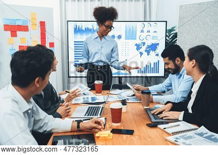 Young African Businesswoman Presenting Data Analysis Dashboard On Tv Screen In Modern Meeting. Busin