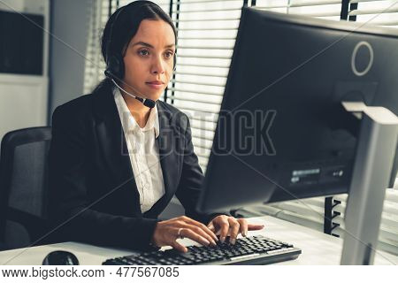 Competent Female Operator Working On Computer And Talking With Clients. Concept Relevant To Both Cal