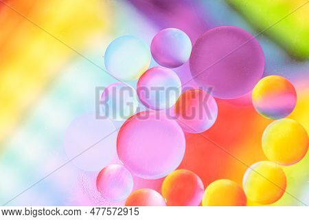 Oil Drops In Water And Air Bubbles, Macro Photo, Selective Focus. Bright Fantasy Rainbow Background.