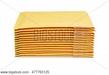 Close-up Of Yellow Padded Mailers Stacked On A White Background.
