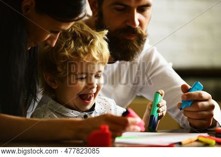 Family Leisure, Happy Mother, Father And Little Child Drawing. Happy Loving Family At Home. Early Ch