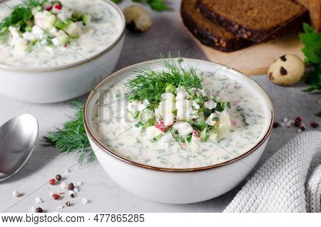 Cold Okroshka Soup With Eggs, Vegetables, Meat, Herbs And Kefir On A Bright Background, Summer Soup