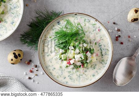 Cold Okroshka Soup With Eggs, Vegetables, Meat, Herbs And Kefir On A Bright Background, Summer Soup