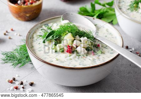 Cold Okroshka Soup With Eggs, Vegetables, Meat, Herbs And Kefir On A Bright Background, Summer Soup