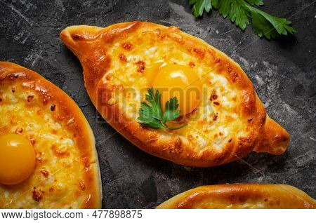 Ajarian Khachapuri, Filled With Cheese And Topped With Egg Yolk, Traditional Georgian Khachapuri On