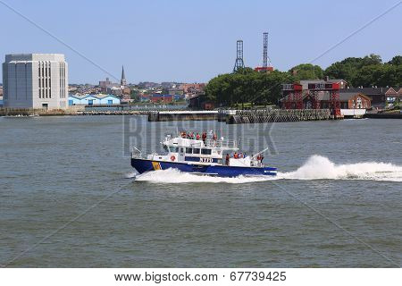 NYPD boat patrolling New York Harbor in the front of Governors Island