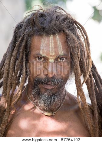 Sadhu, Holy Man Sits On The Ghat Along The Ganges River. Rishikesh, India